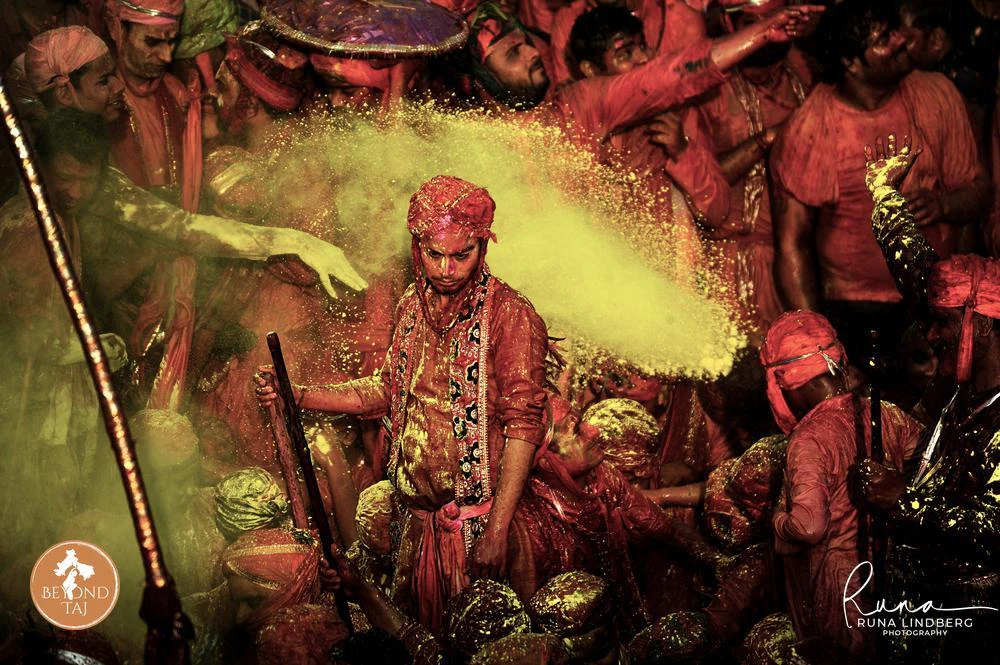 Man drenched in yellow gulal powder during Lathmar Holi in Barsana