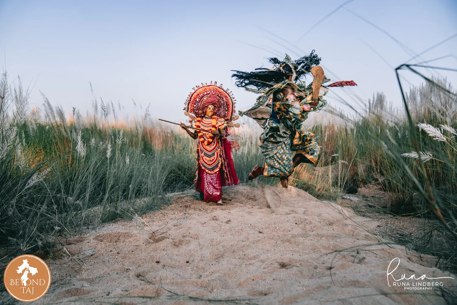 Chhau dancers mid-leap during a masked warrior performance
