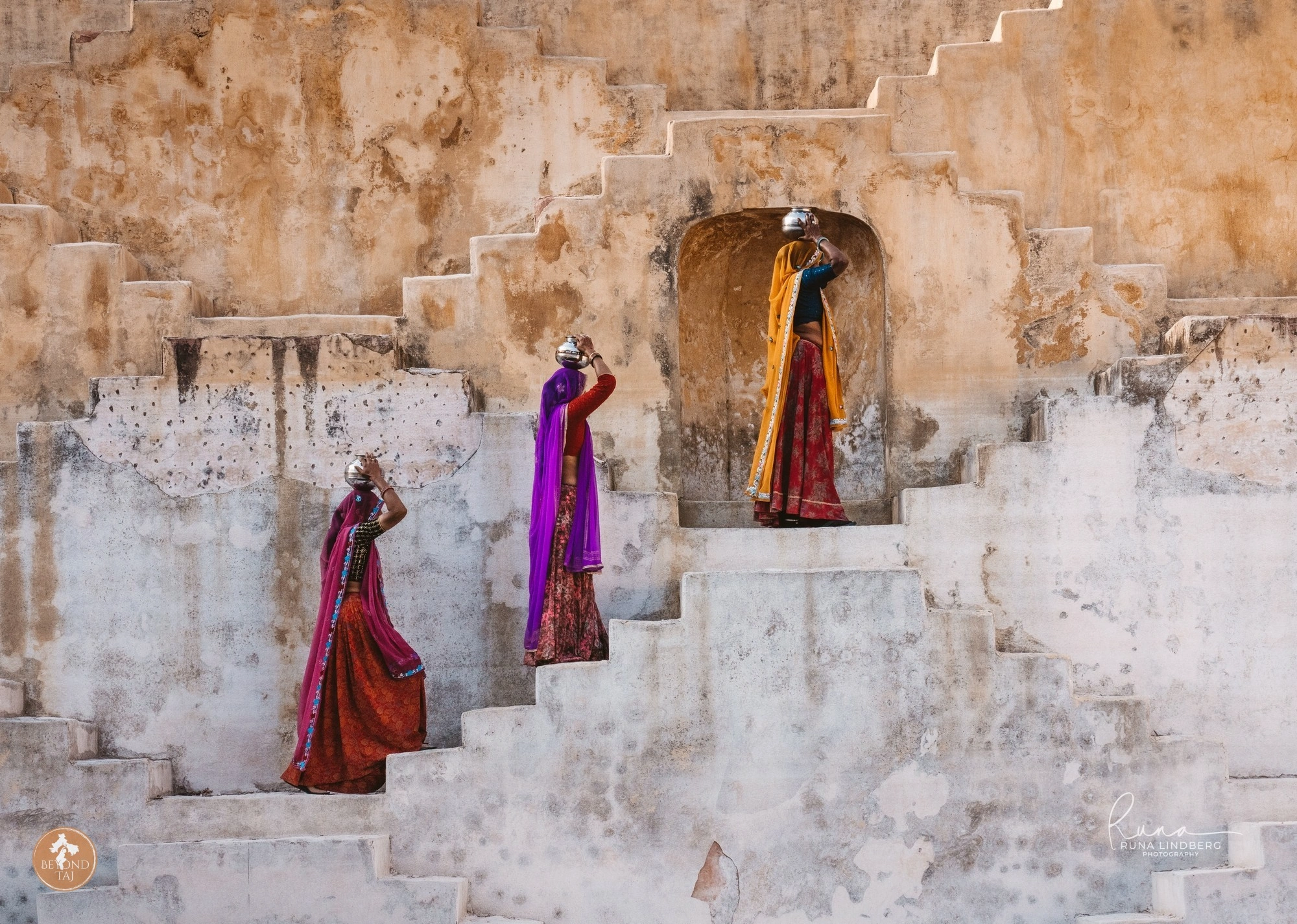 Women in colourful saris descending Panna Meena ka Kund stepwell