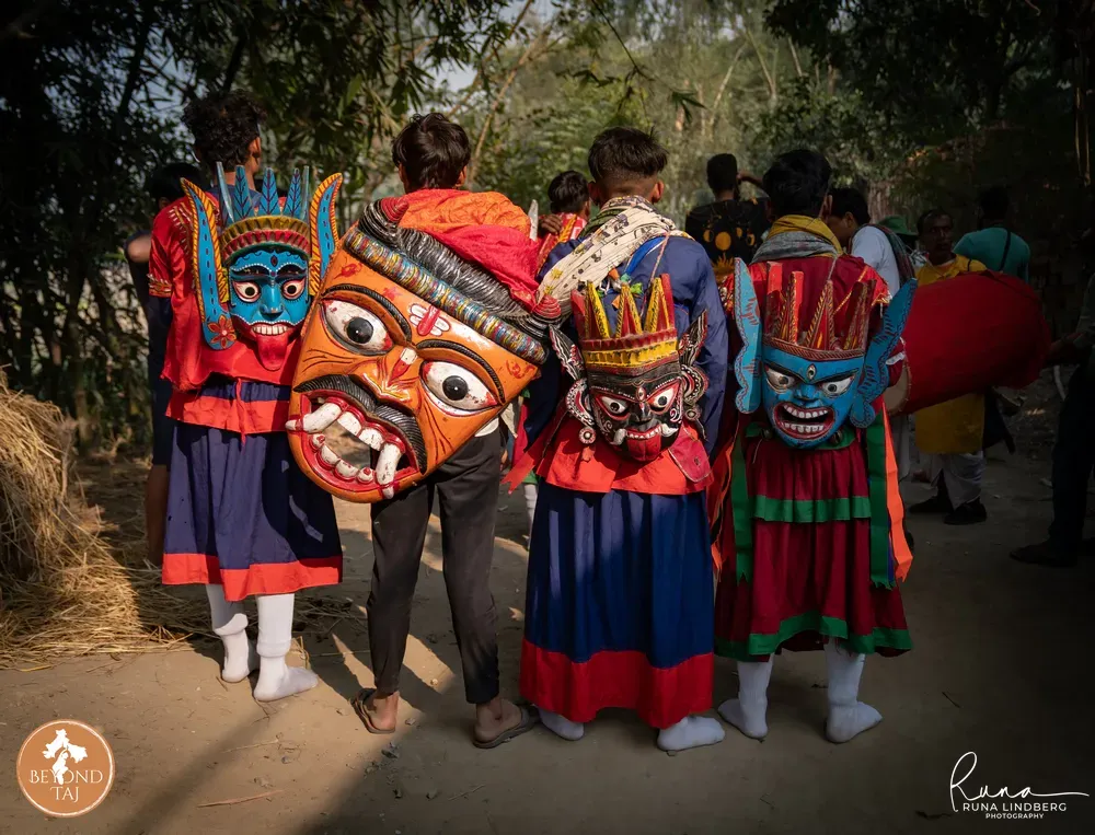 Group of Gomira performers in wooden masks gathered together before the dance begins, West Bengal