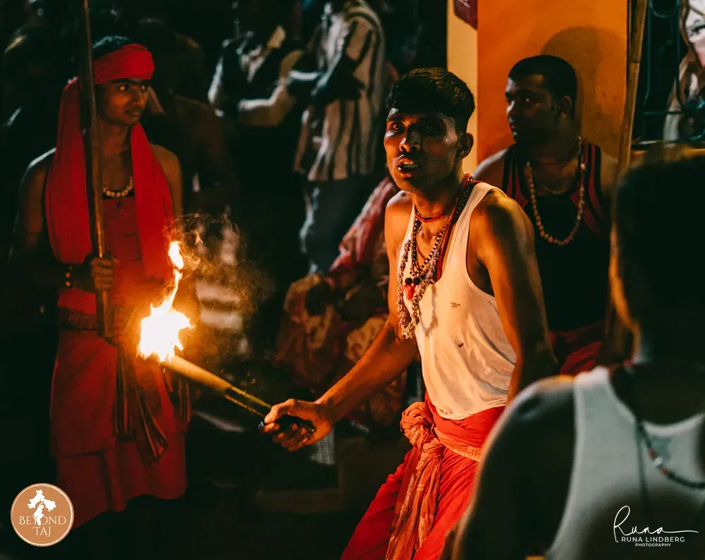 Torch lit, the fire-breather waits for his moment. Kandi.