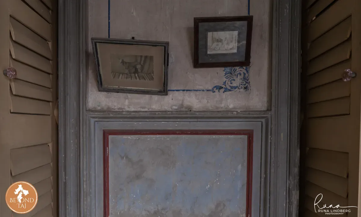 old photographs on a wall in a rajbari